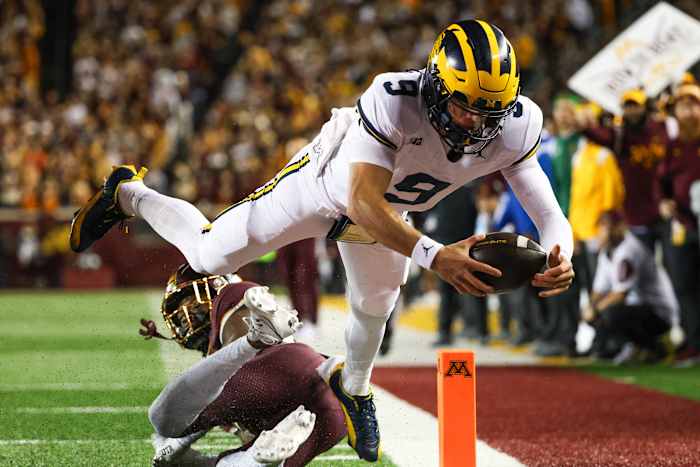 Oct 7, 2023; Minneapolis, Minnesota, USA; Michigan Wolverines quarterback J.J. McCarthy (9) dives for a touchdown against the Minnesota Golden Gophers during the second quarter at Huntington Bank Stadium.